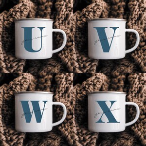 May include: Four white enamel mugs with a silver rim and handle. Each mug features a large blue serif letter U, V, W, or X, with the cursive text your name printed in black below each letter. The mugs are arranged in a grid pattern.