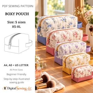 May include: A PDF sewing pattern for a boxy pouch in five sizes from XS to XL. The image displays five quilted fabric pouches with floral patterns, gold zippers, and solid-colored bases, arranged in a row on a wooden surface.