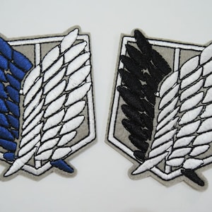 May include: Two embroidered patches featuring the Wings of Freedom symbol from the anime Attack on Titan. One patch has blue and white wings, while the other has black and white wings.