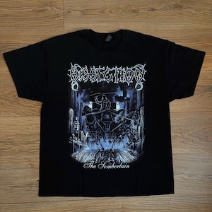 May include: A black short-sleeve t-shirt featuring a graphic print in shades of blue and white. The design displays the text DISSECTION at the top and The Somberlain at the bottom, with an illustration of a horse-drawn carriage in a graveyard.