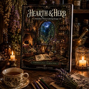 May include: A coloring book titled Hearth & Herb: A Kitchen Witch Coloring Escape by Compass & Quill Studio. The cover features an illustration of a cozy, candlelit kitchen with an open book, herbs, and a crescent moon visible through a window.