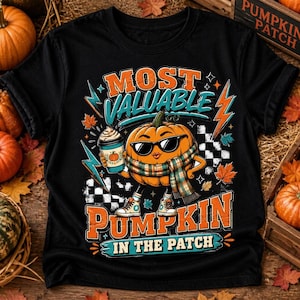 May include: A black t-shirt featuring a graphic of a cartoon pumpkin wearing sunglasses and a plaid scarf, holding a coffee cup. The text reads MOST VALUABLE PUMPKIN IN THE PATCH. The design includes orange and teal lightning bolts and leaves.