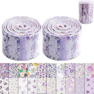 May include: Two rolls of fabric strips featuring a variety of floral patterns in shades of purple, lavender, white, and green. The strips have pinked edges and are displayed alongside a clear cylindrical container filled with additional fabric strips.