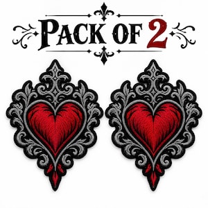 May include: Two embroidered patches featuring a central red heart surrounded by intricate silver and black filigree scrollwork. Above the patches, the text reads PACK OF 2 in black and red lettering, framed by decorative flourishes.