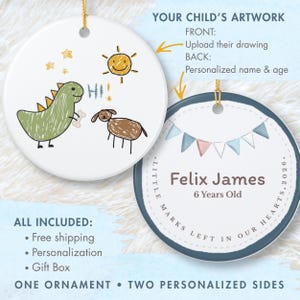 May include: Two round ceramic ornaments with gold hanging strings. One side features a green dinosaur, a brown dog, a yellow sun, and the text HI. The other side displays a blue bunting banner, the name Felix James, 6 Years Old, and the text LITTLE MARKS LEFT IN OUR HEARTS 2026.