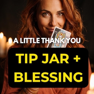 May include: A rectangular black sign with yellow text that reads A LITTLE THANK YOU TIP JAR + BLESSING. The sign is held in front of a person with wavy auburn hair who is holding a tarot card featuring a colorful illustration of a figure.