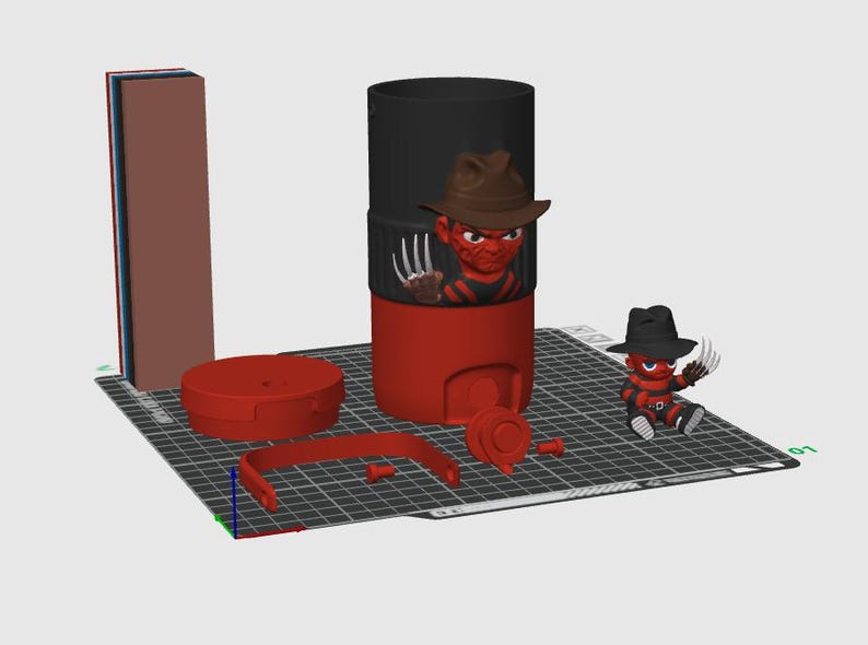 以下が含まれることがあります： 3Dプリントされた組み立てキット。赤と黒の円筒形容器、茶色の帽子と爪付きグローブを身に着けたキャラクターフィギュア、赤い蓋、ハンドル、そして黒い帽子と爪付きグローブを身に着けた小さなフィギュアが含まれています。