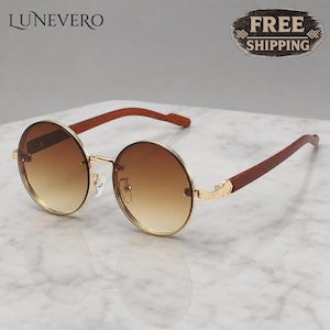 May include: Round sunglasses featuring gold-tone metal rims and bridge, gradient brown lenses, and dark brown wooden temples. The brand name LUNEVERO is visible in the upper left corner, and a badge stating FREE SHIPPING is in the upper right.