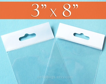 May include: Two clear cellophane bags with white header cards. The bags are 3" x 8" and have a hang hole. The bags are on a light blue background with an orange stripe at the top that reads "3" x 8".