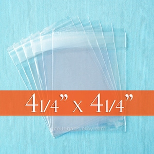 May include: Clear cellophane bags, 4.25 x 4.25 inches, are stacked on a light blue surface. The bags are transparent and have a sealed top. The text "4 1/4" x 4 1/4"" is displayed on an orange banner.
