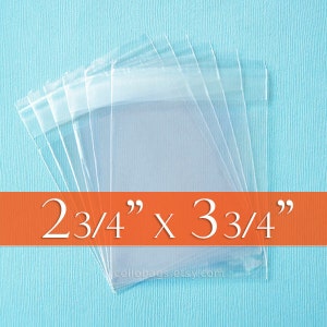 May include: Clear cellophane bags, measuring 2 3/4" x 3 3/4", are stacked on a light blue background. The bags are transparent and have a sealed top. The text "2 3/4" x 3 3/4"" is displayed on an orange banner.