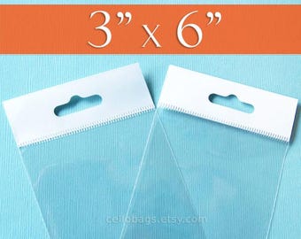 May include: Two clear cellophane bags with white header cards. The bags measure 3" x 6" and have a hang hole. The bags are displayed on a light blue background with an orange stripe at the top.