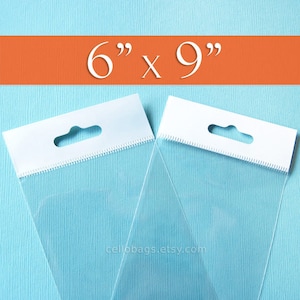 May include: Two clear cellophane bags with white header cards. The bags are 6" x 9" and have a hang hole. The bags are on a light blue background with an orange stripe at the top. The website address cellobags.etsy.com is at the bottom.