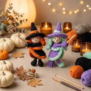 May include: Two crocheted dolls dressed as witches, one in black and orange and the other in purple and light green, each holding a small wooden crochet hook. The dolls feature round wooden faces with simple painted expressions.