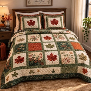 May include: A patchwork quilt and two matching pillow shams featuring a repeating pattern of red, orange, and green maple leaves and berry branches on cream and dark green backgrounds. The bedding set has a quilted texture with stitched details.