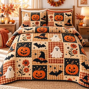 May include: A quilt and two matching pillow shams featuring a patchwork pattern of orange pumpkins, white ghosts, black bats, and witch hats on a background of plaid and floral squares in shades of orange, black, cream, and brown.