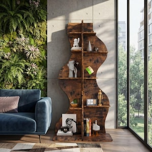 May include: A tall, wavy-shaped bookshelf made of dark brown wood with a distressed finish. The unit features multiple horizontal shelves supported by a central vertical divider, displaying various decorative objects, books, and a small wooden mannequin.