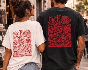 May include: A white t-shirt and a black t-shirt, each featuring a red graphic print on the back. The design includes intricate illustrations and the text King Gizzard & The Lizard Wizard. Both shirts have short sleeves and a crew neckline.