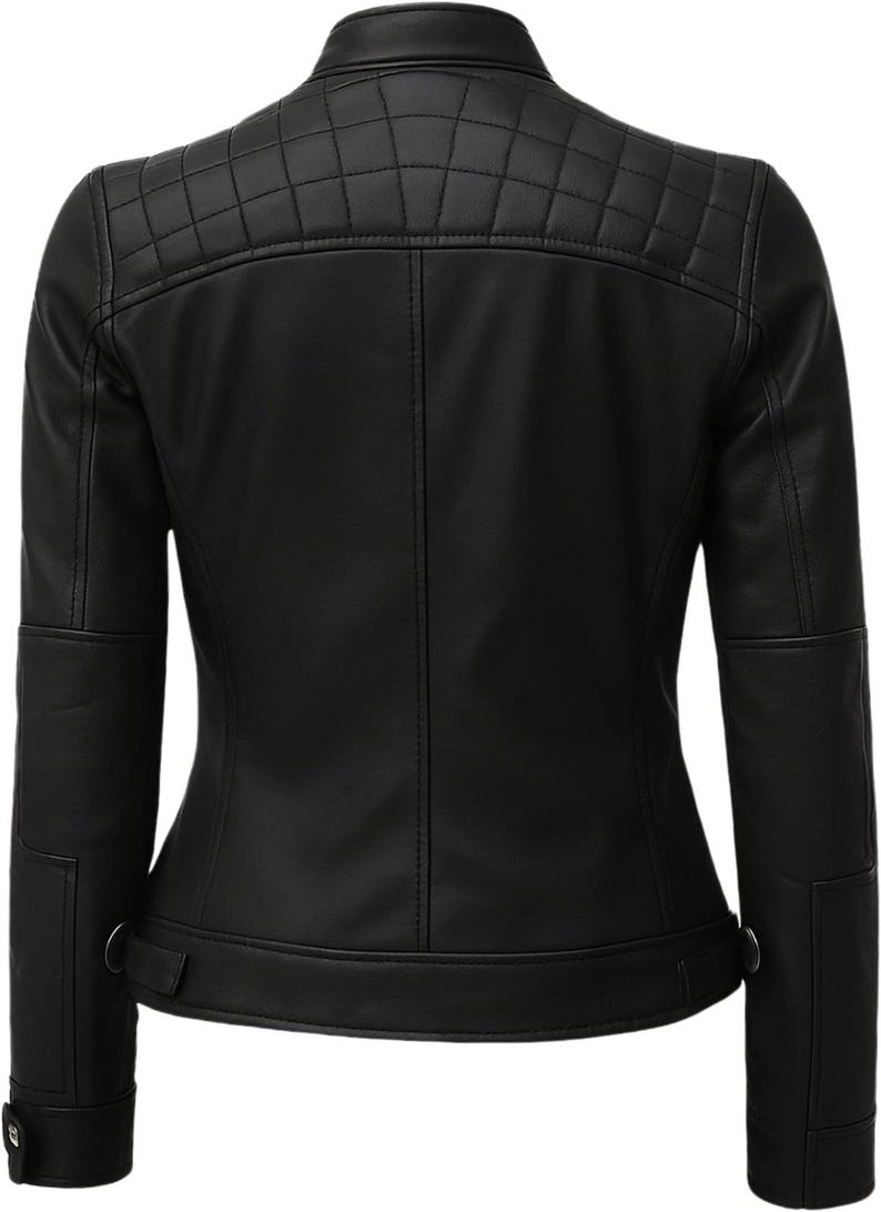 May include: A black jacket featuring a stand-up collar and a quilted panel across the upper back. The garment includes long sleeves with reinforced elbow sections, vertical seam detailing, and adjustable side tabs at the hem with metallic hardware.