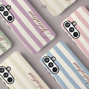 May include: A collection of smartphone cases featuring vertical stripes in various pastel colors including lavender, light blue, pink, and cream. Each case displays the name Valentina in a cursive script font and includes a triple camera cutout.