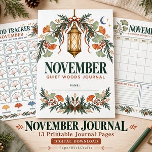 May include: A set of printable journal pages titled November Quiet Woods Journal. The cover features a hanging lantern, ginkgo leaves, and pine branches. Includes a mood tracker with ginkgo leaf icons and a monthly calendar page for November.