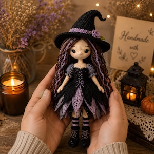 May include: A handcrafted crochet doll featuring a witch wearing a black pointed hat with a purple rose accent. The doll has long wavy brown hair with purple highlights, a black and purple layered dress, and black boots with purple laces.