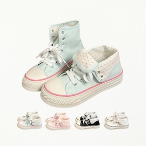 May include: A pair of light blue high-top sneakers with white laces, a white rubber toe cap, and a pink stripe along the sole. The collar features a fold-down design with a white and pink polka dot pattern. Four additional color variations are shown below.