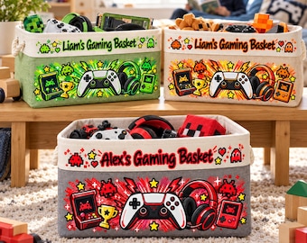 May include: Three rectangular fabric storage baskets featuring gaming-themed graphics including controllers, headsets, and handheld consoles. Two baskets are labeled Liam's Gaming Basket, and one is labeled Alex's Gaming Basket.