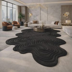 May include: A large, black, organic-shaped area rug featuring a textured, wavy, topographical line pattern. The rug has an irregular, fluid silhouette that spreads across the floor, contrasting with the surrounding light-colored tile flooring.