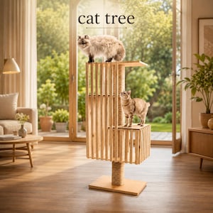 May include: A light-colored wooden cat tree featuring vertical slats, a central sisal-wrapped scratching post, and multiple platforms. The structure includes the text "cat tree" at the top. Two cats are positioned on the different levels.