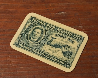 May include: A rectangular cream-colored ticket with dark green ink featuring the text Young's Pier Atlantic City, Admit One, John Young Proprietor, and Package Tickets 15 for 1.00. It displays a portrait of a man and a mermaid illustration.