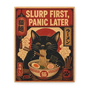May include: A rectangular wall art print featuring a black cat eating ramen with chopsticks. The text reads SLURP FIRST, PANIC LATER. The design includes a red lantern, a bowl of noodles with an egg, and Japanese characters in a vintage style.