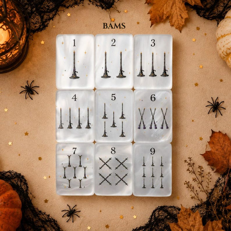 May include: A set of nine rectangular white translucent tiles arranged in a grid, each featuring black illustrations of witch hats and broomsticks. The tiles are numbered one through nine, with varying quantities of the illustrated icons on each tile.