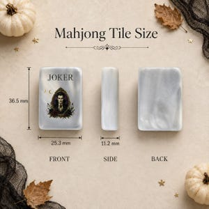 May include: A white pearlescent Mahjong tile shown from the front, side, and back. The front features a Joker illustration in a frame with the text JOKER. Dimensions are 36.5 mm by 25.3 mm by 11.2 mm. The tile has a smooth, marbled finish.