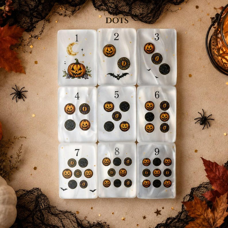 May include: Nine rectangular white translucent tiles arranged in a grid, labeled 1 through 9. Each tile features Halloween-themed graphics including jack-o'-lanterns, cat eyes, bats, and crescent moons, with varying counts of icons per tile.