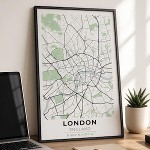 Könnte beinhalten: Ein gerahmter vertikaler Wandkunstdruck mit einem stilisierten Straßenplan von London, England. Die Karte zeigt schwarze Straßenlinien auf weißem Hintergrund mit hellgrünen Parkflächen. Der Text lautet LONDON ENGLAND 51.5074 N, 0.1278 W.