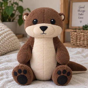 May include: A plush otter toy with dark brown fur on its head, back, and limbs, and a lighter cream-colored belly and face. It features black embroidered eyes, a black nose, a stitched mouth, and dark brown paw pads on its feet.