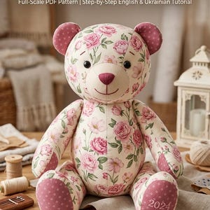 May include: A 50 cm (20 inch) memory bear sewing pattern and assembly guide featuring a floral print bear with pink roses on a cream background. The bear has dark eyes, a stitched nose, and the year 2024 embroidered on one foot pad.
