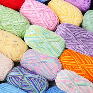 May include: A collection of yarn skeins in various colors including pink, yellow, orange, green, purple, and blue. Each skein features a multi-colored, variegated pattern with thin, interwoven strands of different hues creating a textured appearance.