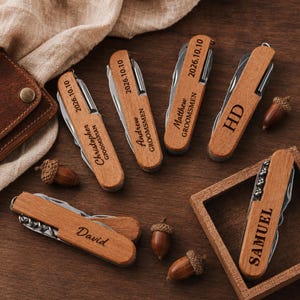 May include: Six folding pocket knives with light brown wooden handles, each engraved with names such as Christopher, Andrew, Matthew, HD, David, and Samuel, along with the date 2026.10.10 or the title GROOMSMEN, featuring metal tool components.