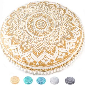May include: A large, round floor cushion featuring a gold and white mandala pattern with intricate floral and geometric details. The edges are finished with small white pom-poms. Five smaller, circular color variations are displayed below.