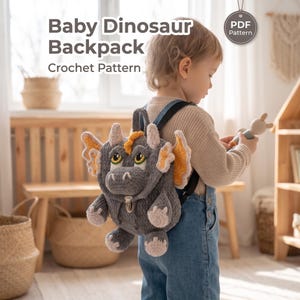 May include: A gray crochet backpack shaped like a baby dinosaur with yellow-accented wings, horns, and a metal clasp closure. The text "Baby Dinosaur Backpack Crochet Pattern" and a "PDF Pattern" badge are visible in the upper portion of the image.