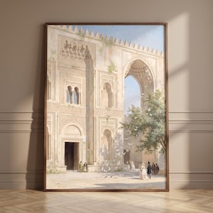 May include: A framed wall art print depicting a large, light-colored stone building with intricate carvings, a tall arched entryway, and a crenelated roofline. Several figures in period clothing stand in the courtyard, with white birds flying.