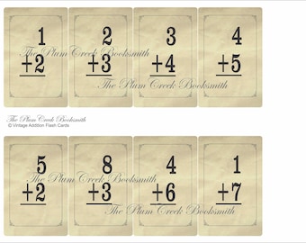 May include: Vintage addition flash cards with a cream background and black text. The cards feature simple addition problems with numbers 1 through 8. The text "The Plum Creek Booksmith" appears on each card.