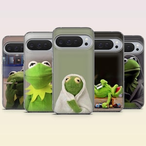 May include: Five clear phone cases featuring various printed images of a green frog character. The designs include the frog smoking, smiling, wrapped in a white towel, lying down with bottles, and wearing a dark hooded cloak over its head.