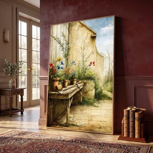 May include: A framed vertical wall art print depicting a rustic outdoor scene with a wooden potting bench, terracotta pots filled with colorful red, yellow, and blue flowers, and scattered papers on the ground against a weathered stone wall.