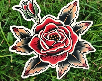 May include: A red rose with green leaves and a bud. The rose is drawn in a traditional tattoo style.