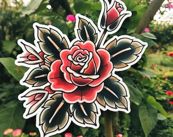 May include: A traditional tattoo style illustration of a red rose with green leaves. The rose is in full bloom and has a delicate white centre. The leaves are detailed and have a dark green colour.
