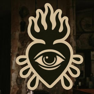 May include: A black and white illustration of a heart with an eye inside, surrounded by flames. The heart is dripping with tears.