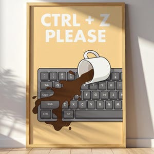 May include: A framed wall art print featuring a light yellow background with the white text CTRL + Z PLEASE at the top. Below the text, a white coffee mug is tipped over on a dark gray computer keyboard, spilling dark brown liquid across it.